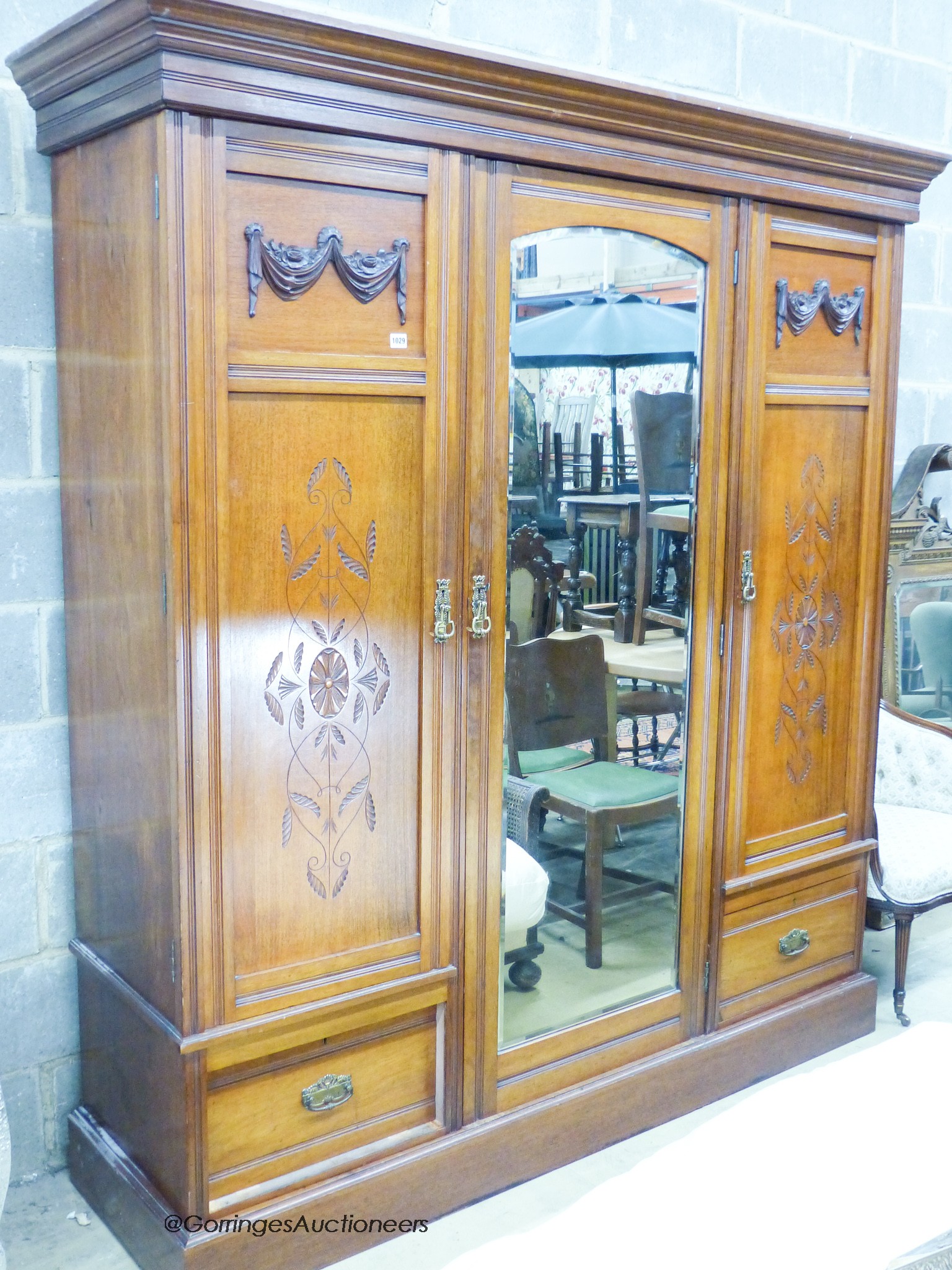 A late Victorian walnut triple door mirrored wardrobe, W.180cm D.58cm H.209cm